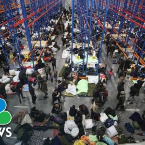 Migrants Swap Makeshift Forest Camp For Warehouse